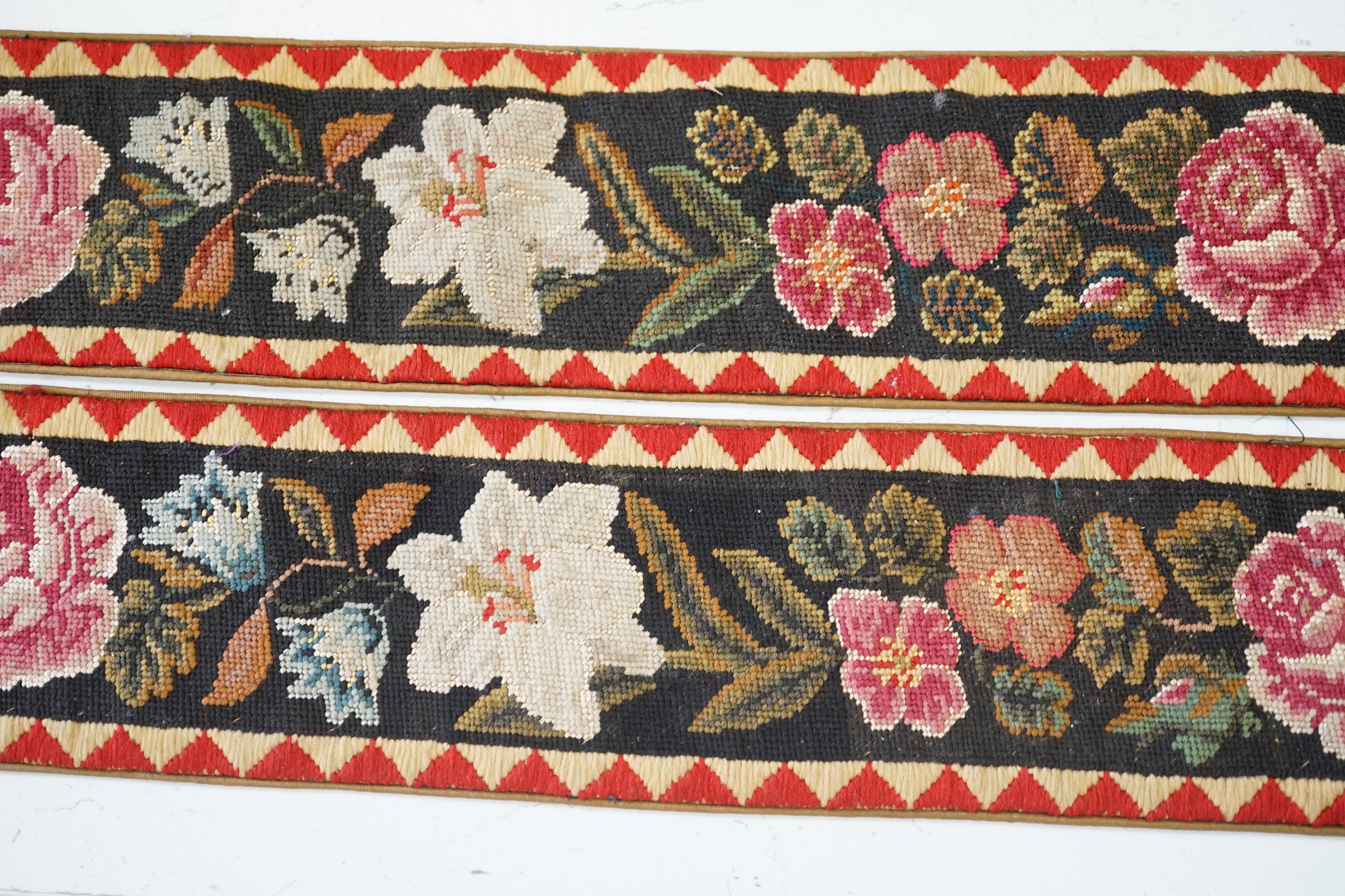 A pair of Victorian petit pointe embroidered bell pulls, 163cm including gilt metal hanger and silk rosette